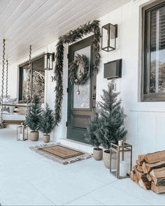 A porch with christmas decorations and candles.