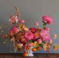 A vase filled with flowers on top of a wooden table.
